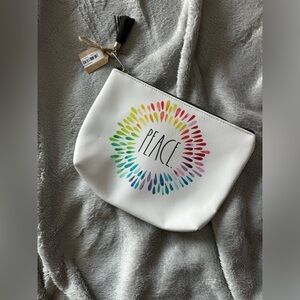 NWT Rae Dunn Peace makeup bag. Made with PVC and polyester.